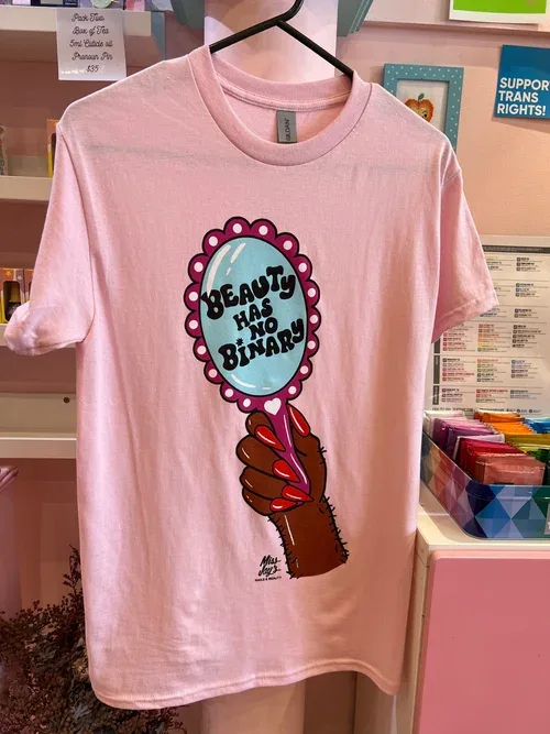 The pink 'Beauty Has No Binary' t-shirt — product shot